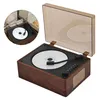 A close-up, angled view of a portable CD player with a wooden-grain finish, showing the open lid and the CD inside. Produktbild-Vorschau