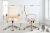 Two views of a cream-colored office chair with gold accents, with dimensions indicated by dashed lines and text. Produktbild-Vorschau