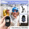 Two people in climbing gear in a mountainous landscape, with one holding a small black camera. Produktbild-Vorschau