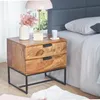 A wooden nightstand with two drawers next to a bed. Podgląd zdjęcia produktu