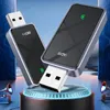 Two black USB adapters with silver trim are displayed on a circular platform with blue lighting, against a background of abstract blue geometric shapes and a starry sky. Produktbild-Vorschau