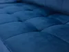 A close-up of a tufted blue sofa cushion. Náhled obrázku produktu