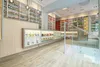Interior of a well-lit pharmacy or health store with shelves stocked with products. Produktbild-Vorschau