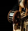 A close-up shot of a wooden model film projector with film reel. Produktbild-Vorschau