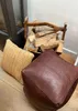 Two poufs are placed on a wooden floor next to a fireplace with a log holder filled with firewood. Náhled obrázku produktu
