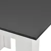 Close-up of the corner of a table with a dark gray top and white legs. Anteprima dell’immagine prodotto
