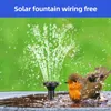A small solar-powered fountain is operating in a bird bath, with a robin bathing in the water. Náhled obrázku produktu