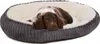 A brown and white puppy lying in a gray and cream dog bed. Produktbild-Vorschau