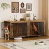 Two dogs are inside a wooden dog crate furniture piece, which is decorated with framed pictures and bottles on top. Náhľad obrázku produktu
