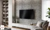 A modern living room with a TV mounted on a textured wall, a long media console, and a comfortable armchair. Náhled obrázku produktu