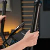 Close-up of hands holding the handlebars of an elliptical trainer. Produktbild-Vorschau