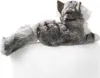 A plush toy cat lying down on a white surface. Náhľad obrázku produktu
