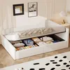 A white upholstered daybed with storage drawers underneath, filled with folded clothes and storage bins. The bed is made with a beige quilted comforter. Anteprima dell’immagine prodotto
