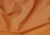 Close-up of wrinkled orange fabric. Náhled obrázku produktu
