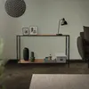 A console table with decorative items and a lamp in a living room setting. Náhled obrázku produktu