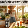 A woman in a kitchen with a blender filled with fruit and ice, and a glass of juice on a wooden table. Produktbild-Vorschau