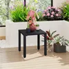 A black metal side table with plants on it, placed on a wooden deck with a planter in the background. Produktbild-Vorschau