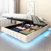 A bed with its storage compartment open, revealing neatly folded linens and towels. The bed has LED lighting underneath. Náhľad obrázku produktu