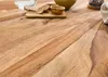 A close-up shot of a wooden table with some kitchen utensils on it. Produktbild-Vorschau
