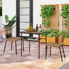An outdoor patio scene with a table and chairs set, plants, and a door. Produktbild-Vorschau