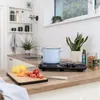 A kitchen counter with a portable induction cooktop, a pot of food, and cooking ingredients. Náhľad obrázku produktu