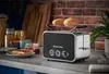 A Russell Hobbs toaster is shown on a kitchen counter with toast and jam. Produktbild-Vorschau