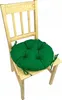 A round green cushion is placed on a wooden chair. Produktbild-Vorschau