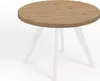 A round dining table with a wood-look top and white legs, shown against a white background. Voir les images du produit