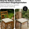 Two chairs with cushions, one wooden and one rattan, placed outdoors on a balcony or patio. Voir les images du produit
