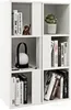 A white cube-shaped bookshelf filled with books and decorative items. Produktbild-Vorschau