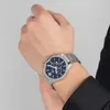 A man's wrist wearing a silver and blue Festina watch. Produktbild-Vorschau