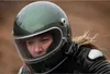 A woman wearing a motorcycle helmet and jacket, looking forward. Podgląd zdjęcia produktu