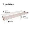 A drying rack is shown in three different positions: open outwards, open inwards, and closed. The image includes text labels indicating these positions. Voir les images du produit