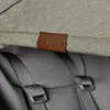 A close-up view of a leather tag with the word "DELUXE" embossed on it, attached to a stroller. Náhled obrázku produktu