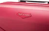 Close-up of a pink suitcase with a silver logo. Náhľad obrázku produktu