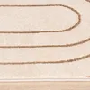 A close-up view of a cream-colored rug with abstract brown geometric lines. Produktbild-Vorschau