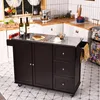 A kitchen cart with a stainless steel top is shown in a kitchen setting with tiled floors and white tiled walls. Podgląd zdjęcia produktu