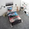 A bedroom scene with a bed featuring fire truck themed bedding, a chair, a bookshelf, and wall art. Podgląd zdjęcia produktu