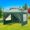 A green pop-up gazebo set up on a grassy lawn in front of a house. Podgląd zdjęcia produktu