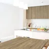 A kitchen scene with a table in the foreground and a sink and cabinets in the background. Produktbild-Vorschau