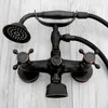 A retro-style black bathtub faucet with a handheld showerhead, mounted on a light-colored wooden background. Anteprima dell’immagine prodotto