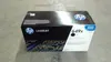 A black and white HP LaserJet toner cartridge box is shown on a concrete floor. Produktbild-Vorschau