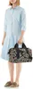 A woman is standing and holding a bag. Produktbild-Vorschau