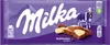 A Milka chocolate bar with a cow and mountain landscape on the packaging. Náhled obrázku produktu