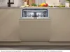 A built-in dishwasher is shown open in a modern kitchen setting, with food items and dishes visible on the countertop behind it. Produktbild-Vorschau
