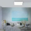 A modern living room with a sofa, a large painting of the sea, and a speaker. Produktbild-Vorschau