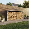 A log store filled with firewood in a garden setting, next to a wooden fence with string lights. Podgląd zdjęcia produktu