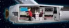 A Playmobil figure in a red uniform stands inside a model of a spaceship's interior, interacting with control panels and a glowing device. Podgląd zdjęcia produktu