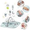 A collage of images showing a baby play mat with various toys and close-ups of its features and care instructions. Voir les images du produit