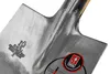 A close-up view of the metal head of a shovel, showing brand markings and a quality seal. Náhľad obrázku produktu